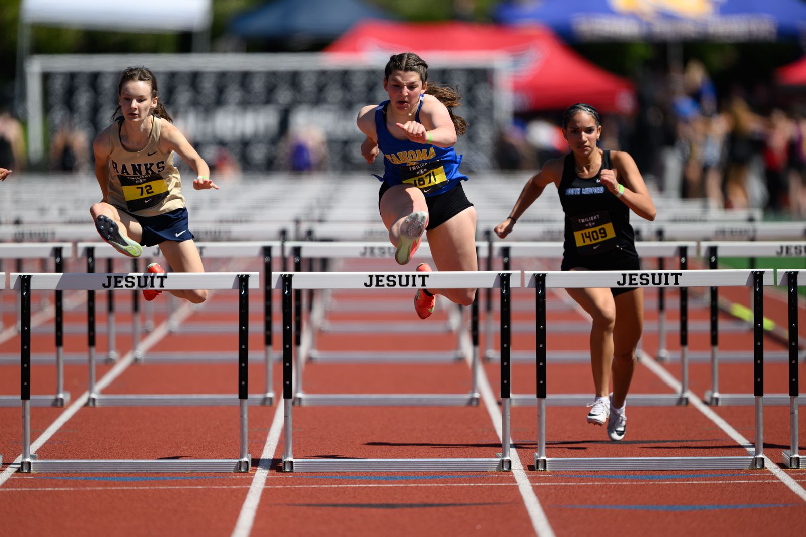 Hurdlers mid jump sports — Sideline Studio PDX