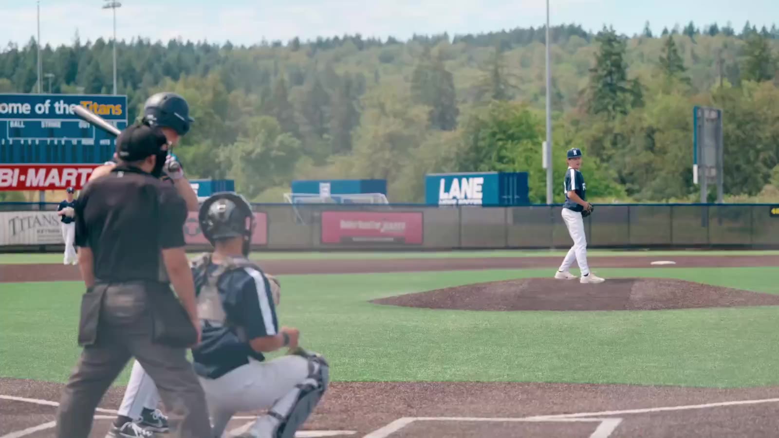 Pitcher on the mound as the batter waits — game footage from a Sideline Studio PDX recruiting shoot