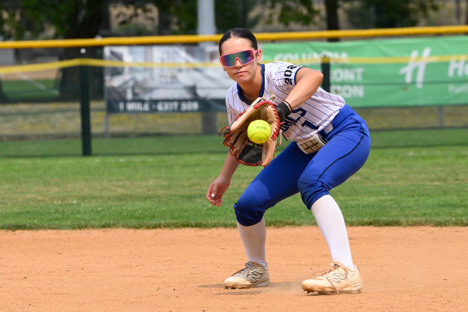 She crouches low, glove open, tracking the ball as it settles into the pocket. 2026 TC World Series Softball, Portland Oregon, 2026.