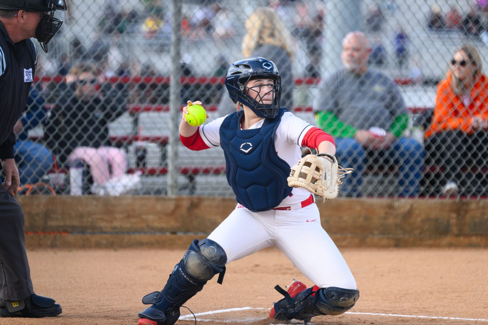 Westview softball catcher cocks arm back to throw the ball during a senior night game.